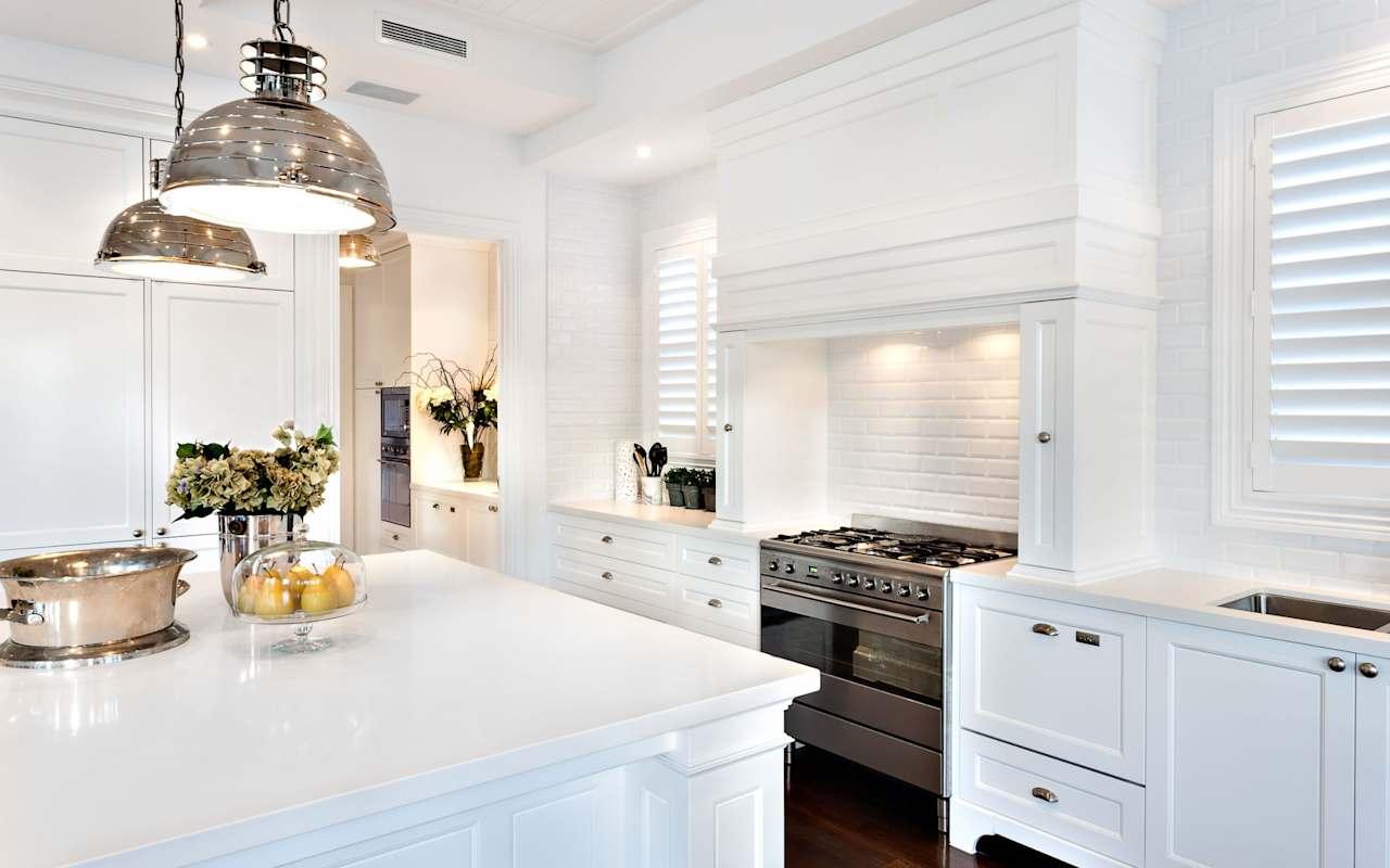 Beautiful luxury kitchen with white cabinets and stainless steel appliances